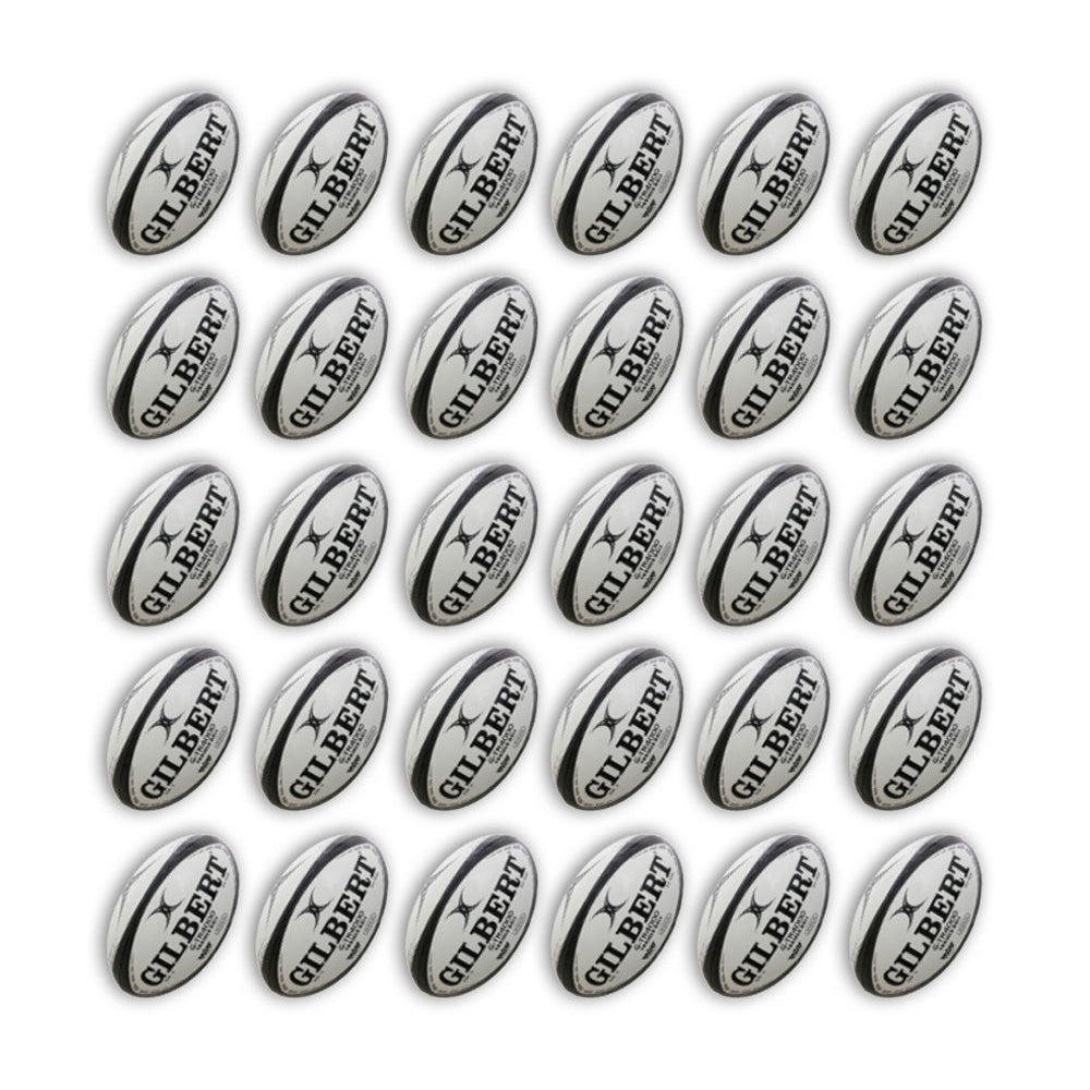 Gilbert G-TR4000 trainer rugby balls in vibrant white and green, stacked neatly with two large breathable ball bags included