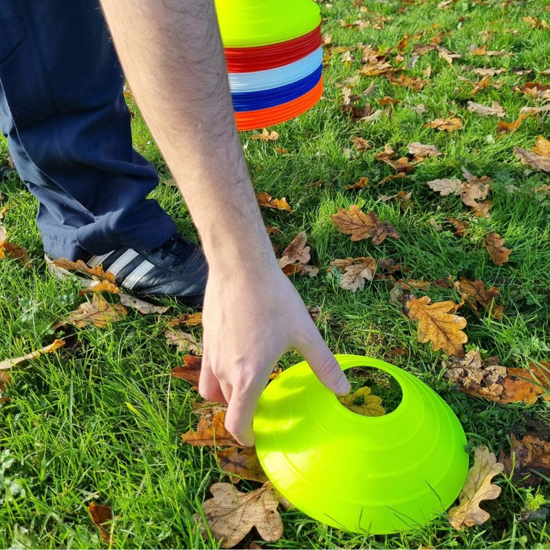 Coach placing marker cones for agility training