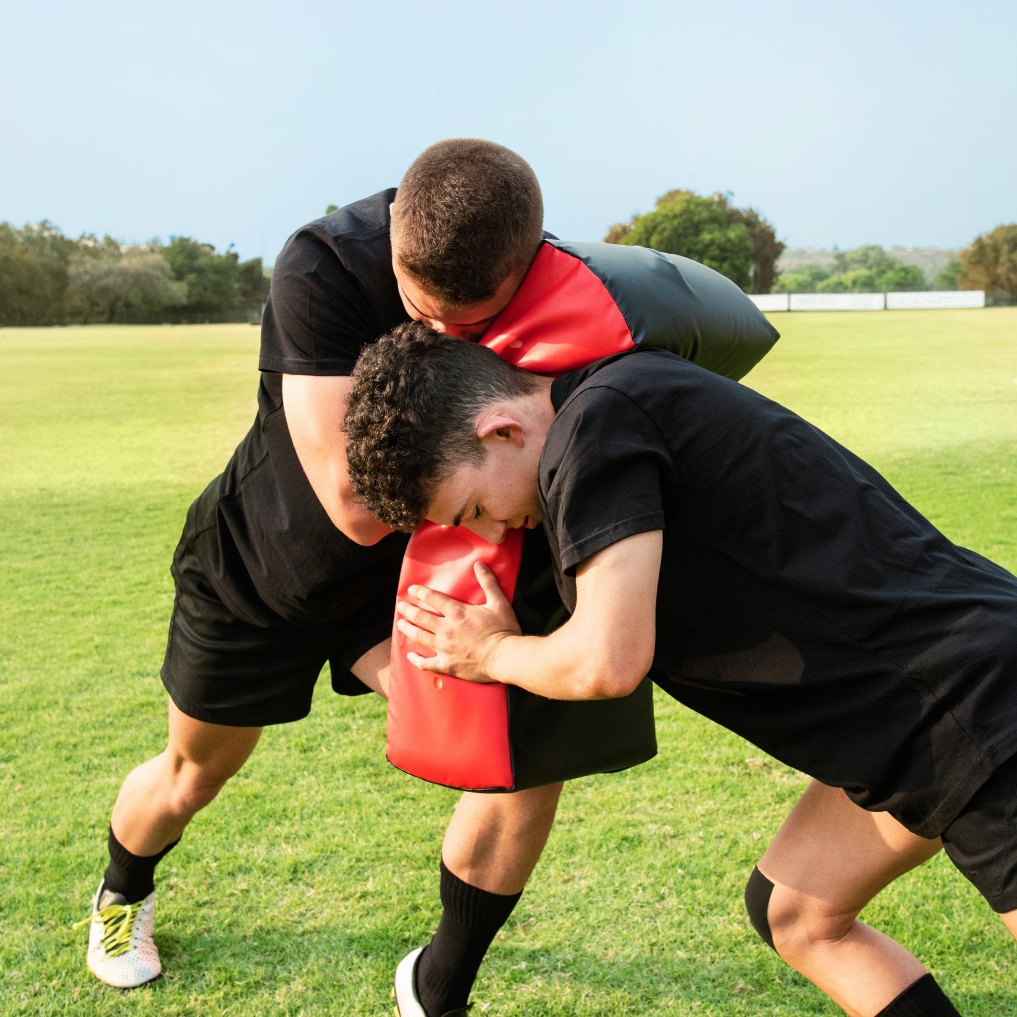 Ram Rugby Curve Hit Shield in use during rugby training, showing durable padded design for contact drills and tackling skills development